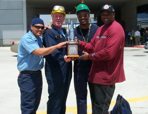 Sanitation winning team with trophy